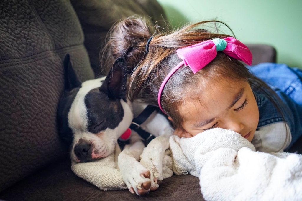 girl sleeping with puppy