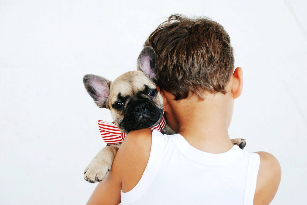 boy hugging dog