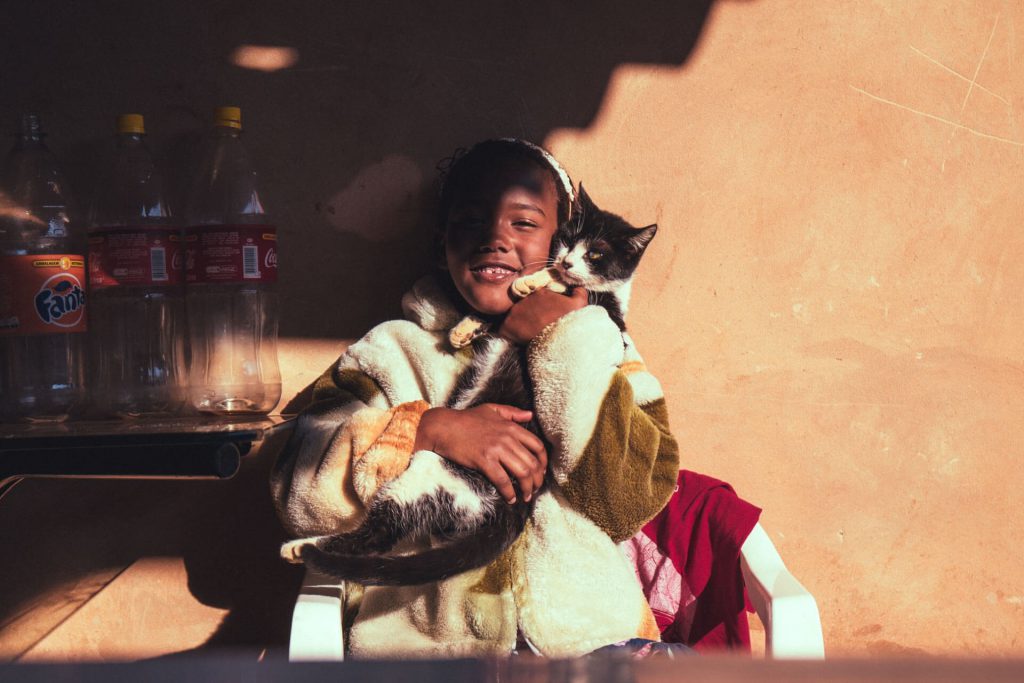 girl hugging cat